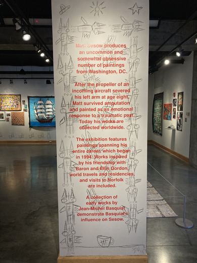 The introduction to the show, lettered in red on a gallery column.