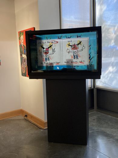 The MagicBox touch display, with Matt's illustrated love-story booklets and a timelapse of him painting "Trumpeting."