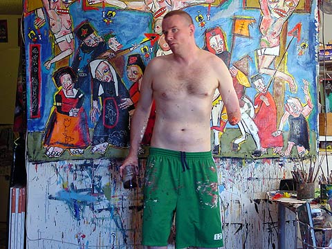 In front of a new painting, brush still in hand.