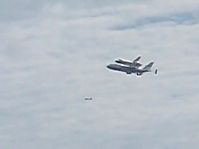 Discovery and its carrier jet over Adams Morgan.