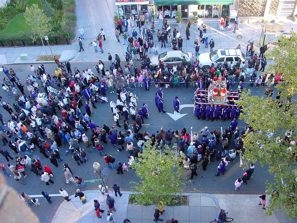 “This happens every last Sunday in October outside Sesow’s studio”: the Señor de los Milagros procession of Washington’s Peruvian community, shot from the studio window.