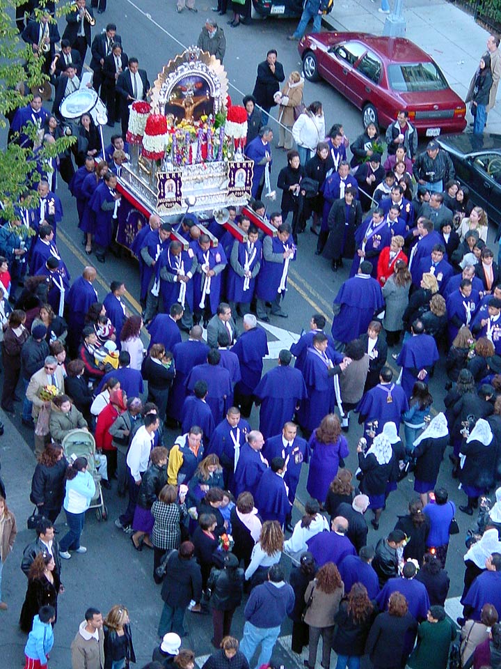 The purple-robed brotherhood carries the image of the Lord of Miracles past the studio, October 29, 2006.